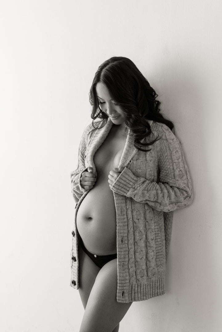 maternity boudoir photography woman wearing patterned sweater dark hair black underwear