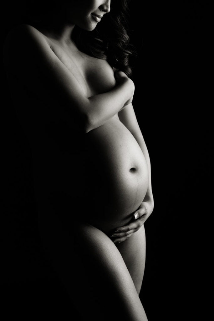 sexy silhouette maternity boudoir photography nude topless holding baby bump