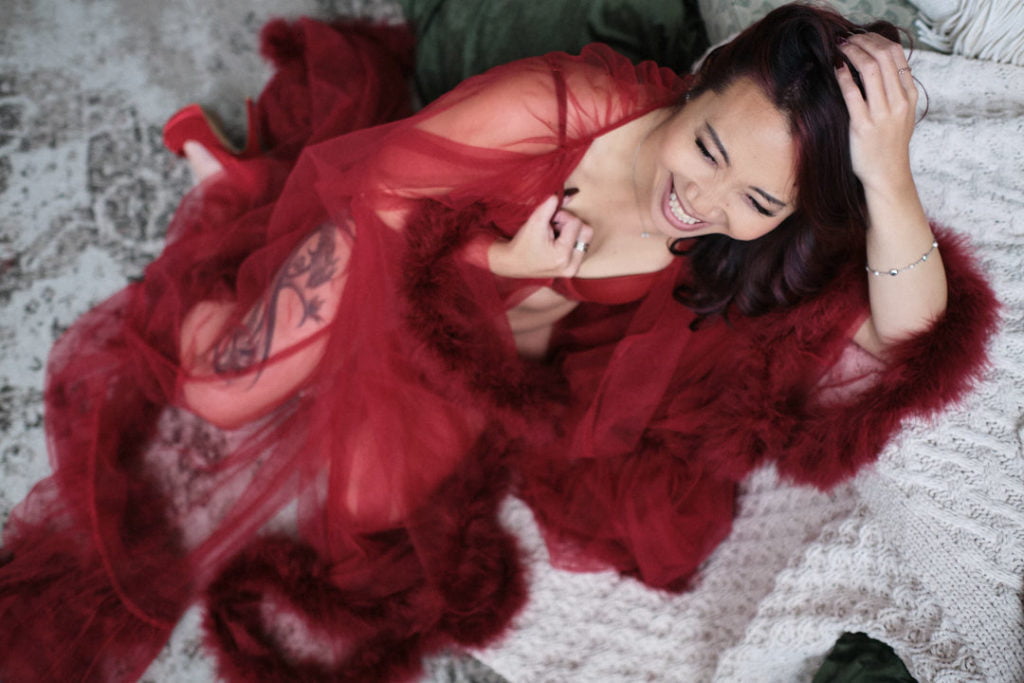 woman smiling in red lingerie robe heels dark red hair