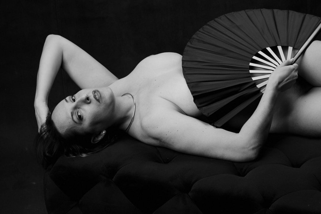sensual black and white boudoir woman holding fan
